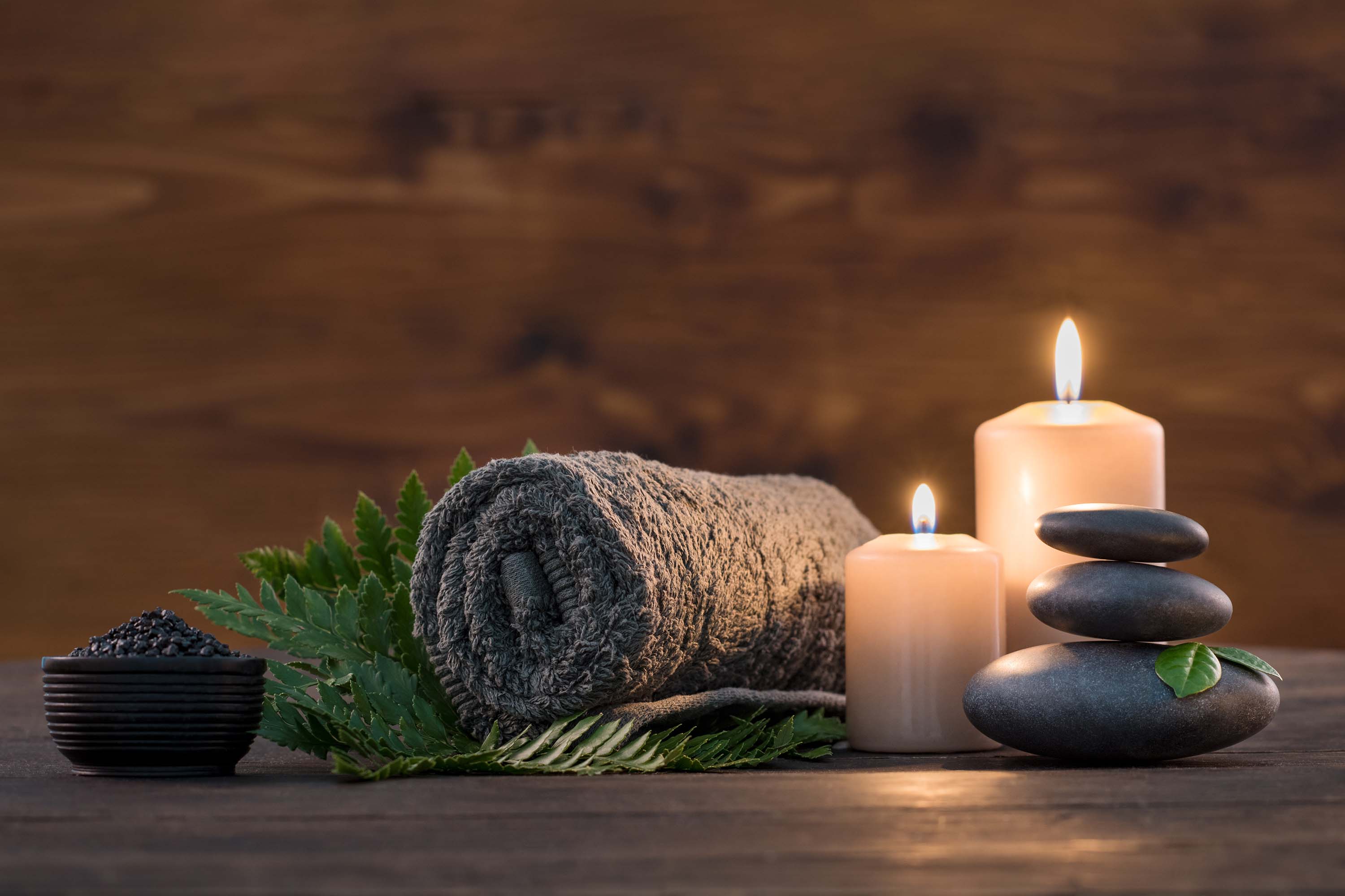 Relaxing candles with hot stones and towel